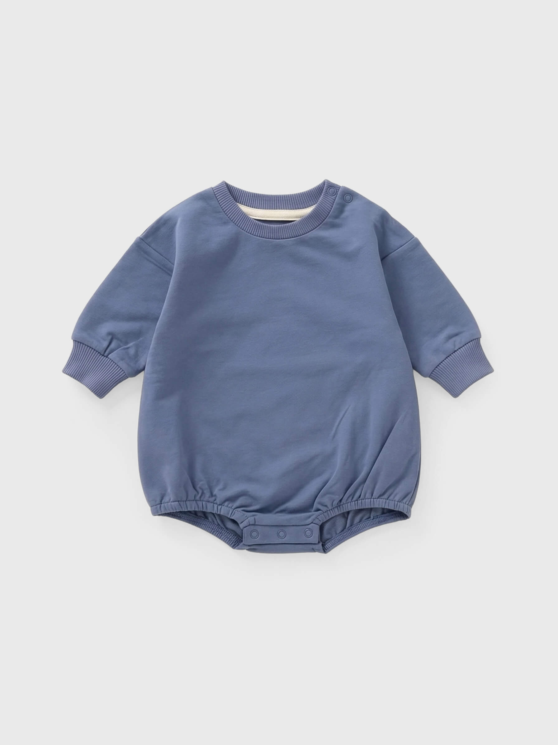Blue baby romper on a light gray background